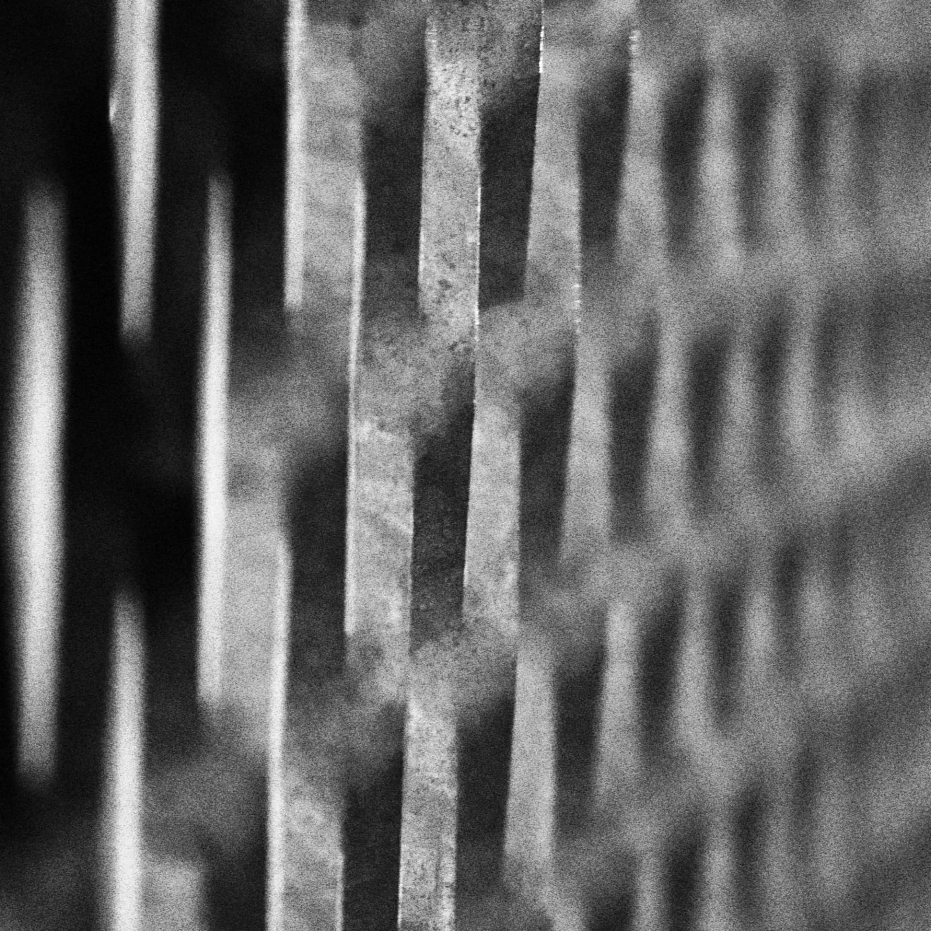 Detalhe de lâminas metálicas verticais em preto e branco
